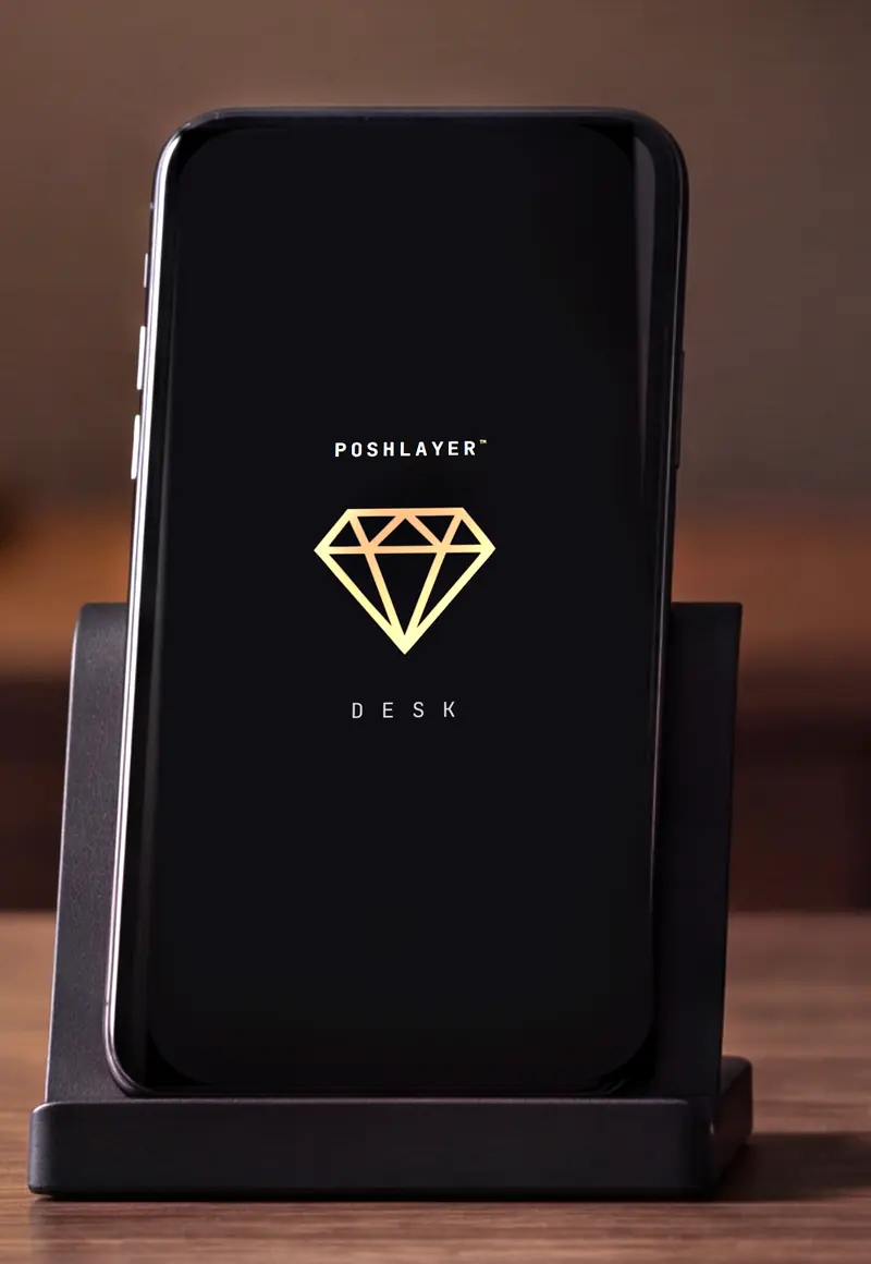 A close view of the phone in its dock, showing the Desk opening screen.