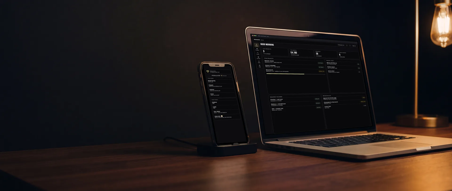 PoshLayer Desk open in a browser on a laptop, and the same account open on the phone beside it.
